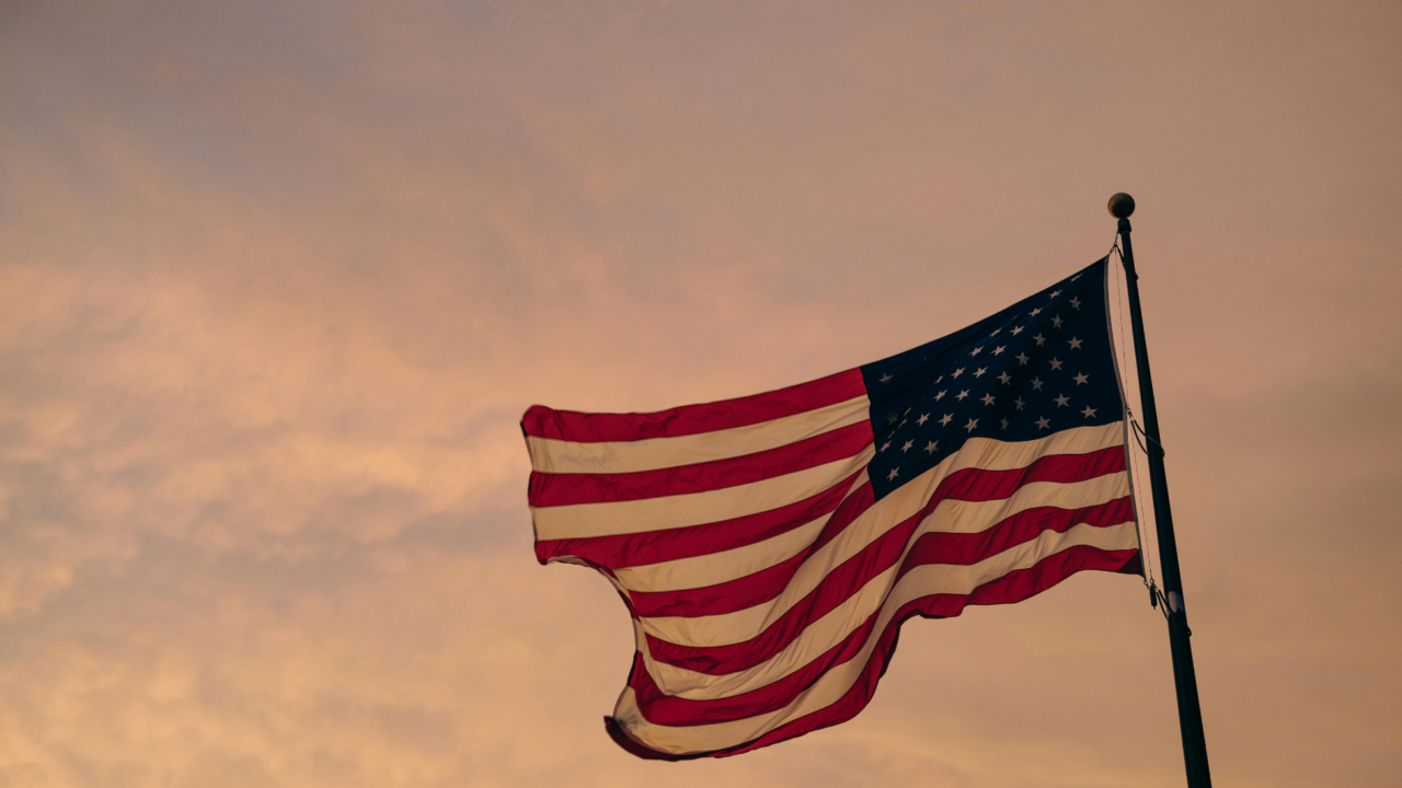 American flag waving during a sunset